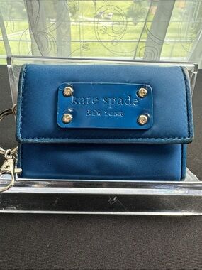 kate spade blue compact flap wallet with gold-tone plaque